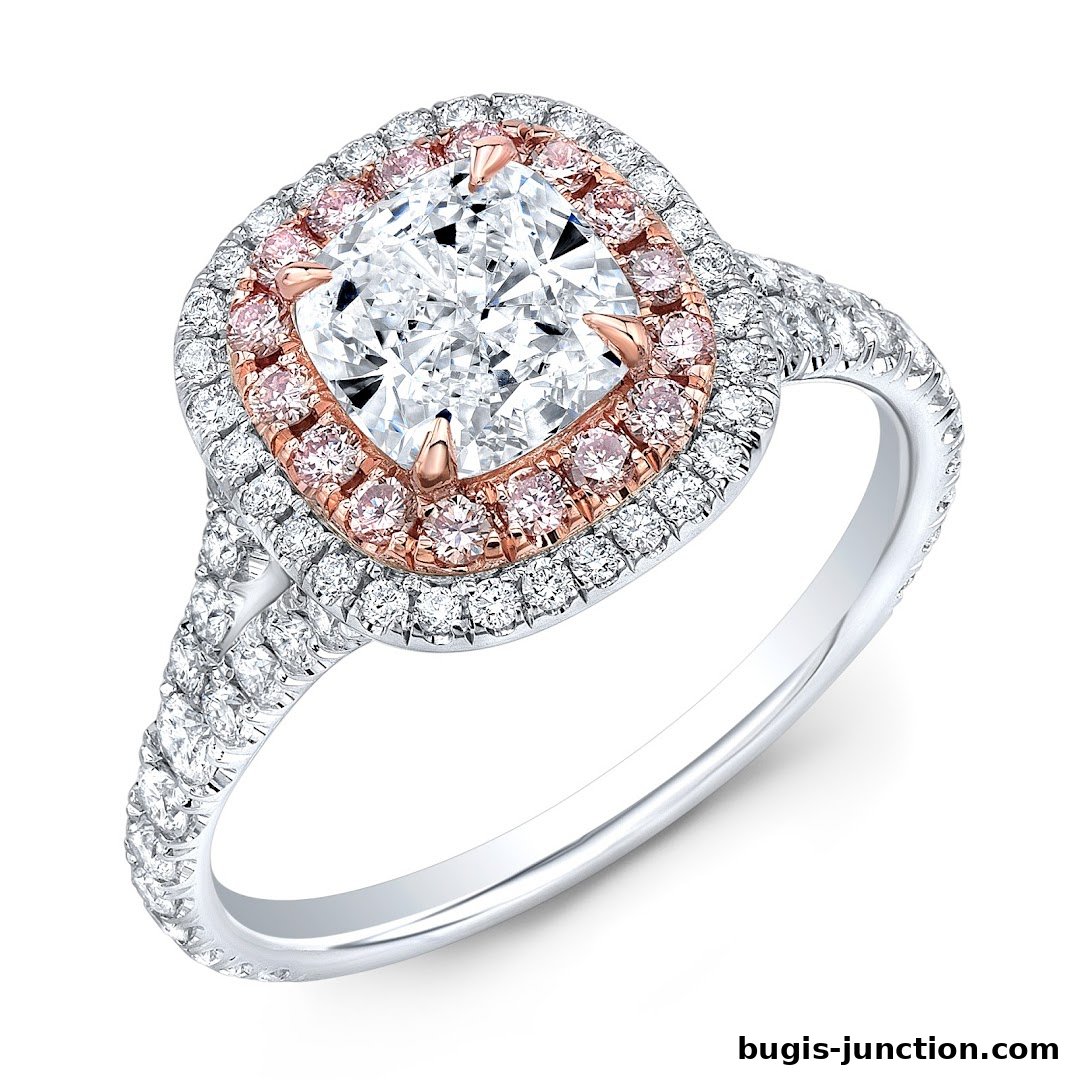 A stunning diamond engagement ring with a cushion-cut center stone and pink diamond halo.