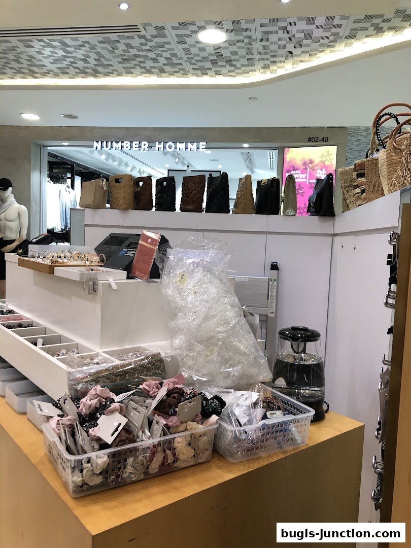 A retail shop interior displaying various bags and hair accessories.