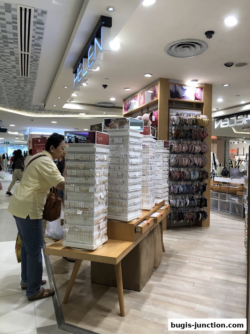 A woman browses a display of earrings and headbands at the Helen store.