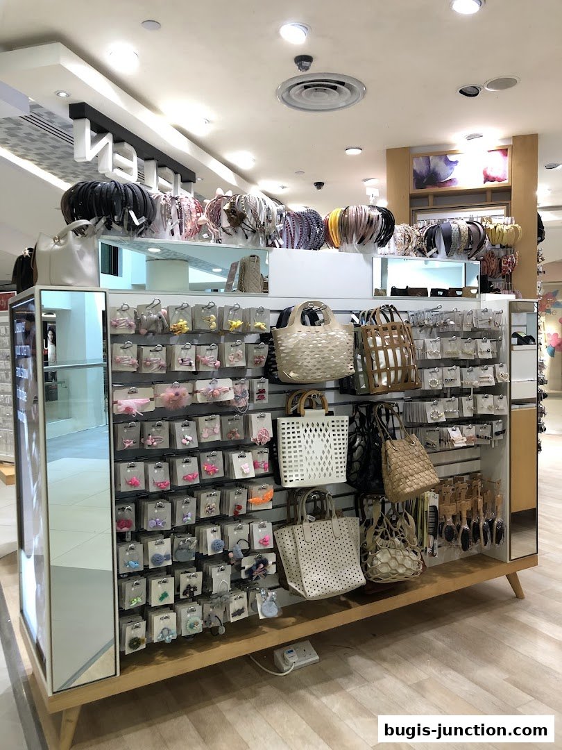 A retail display featuring a variety of hair accessories and handbags.