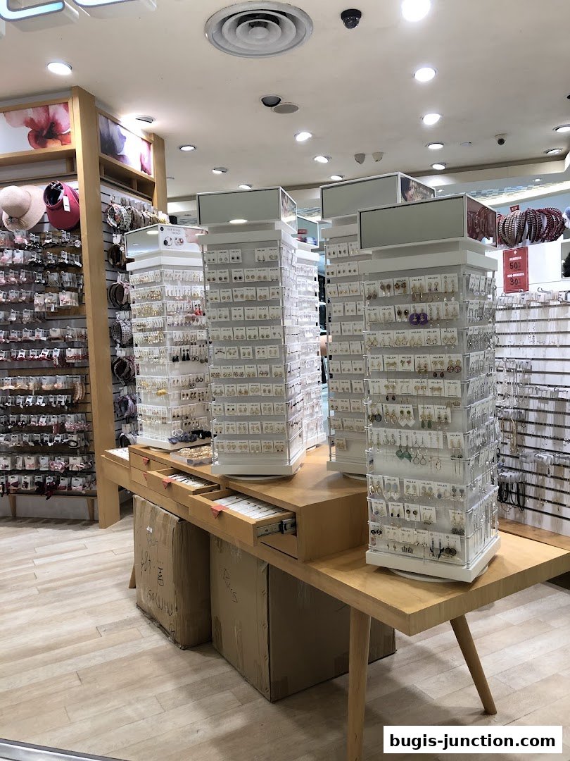 Interior view of a jewelry store displaying earrings and accessories on rotating stands.