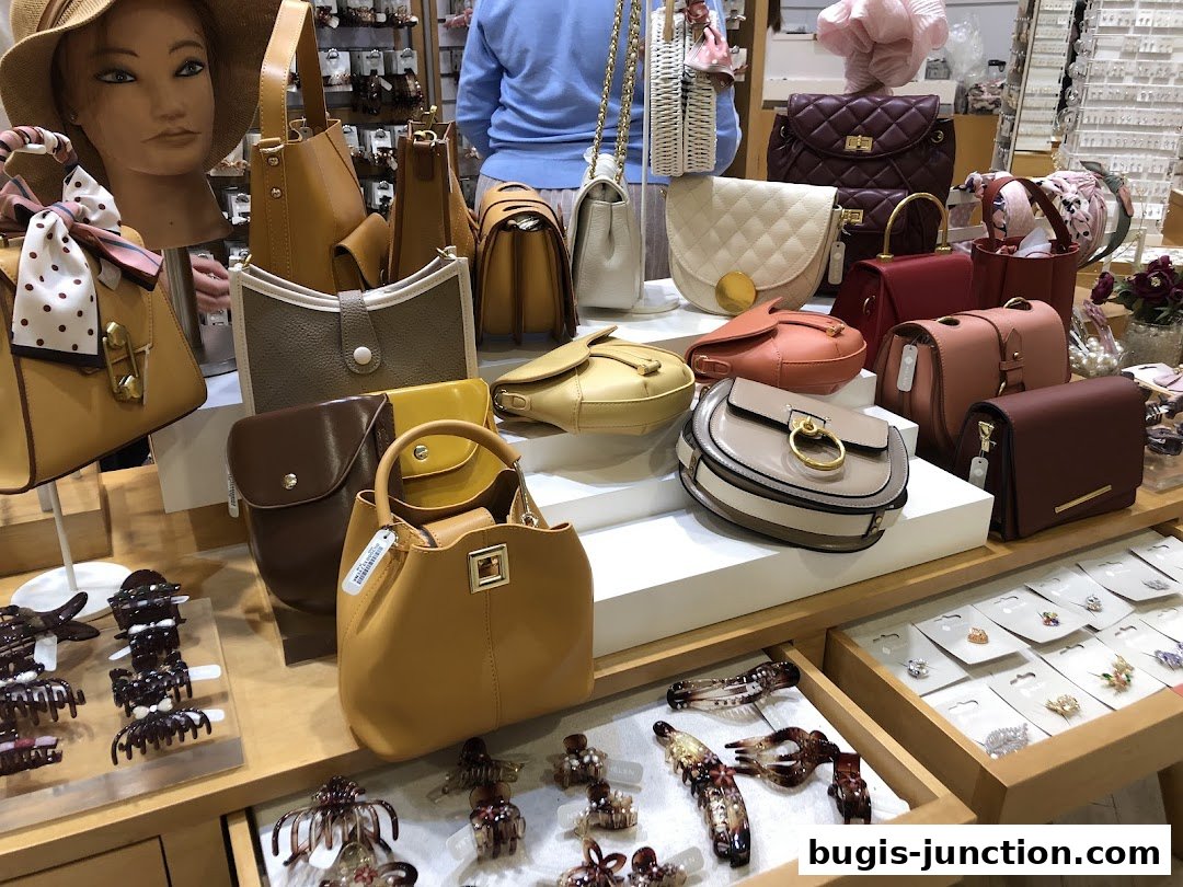 A display of various handbags and hair accessories in a retail store.