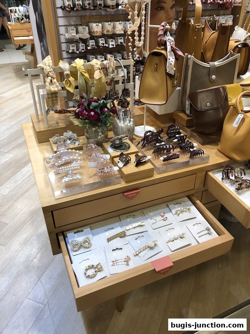 A display of hair accessories and handbags in a retail store.