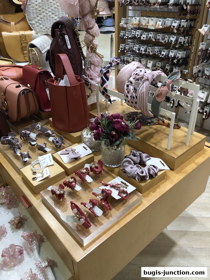 A display of fashionable hair accessories and handbags in a retail store.