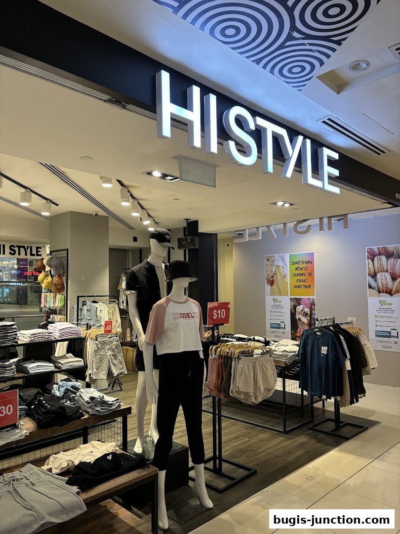 A fashion store display featuring mannequins and clothing racks with various apparel.