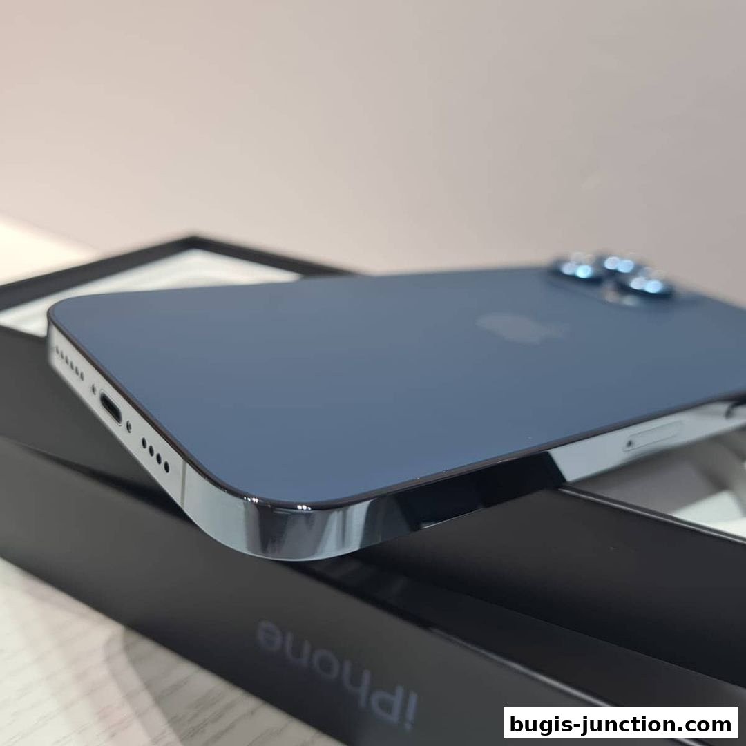 A close-up shot of a blue iPhone 13 Pro Max on its black box.