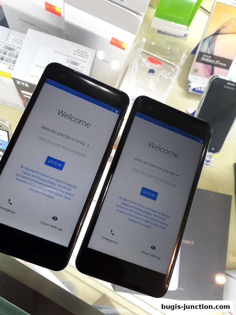 Two smartphones displaying a welcome screen with language selection options.