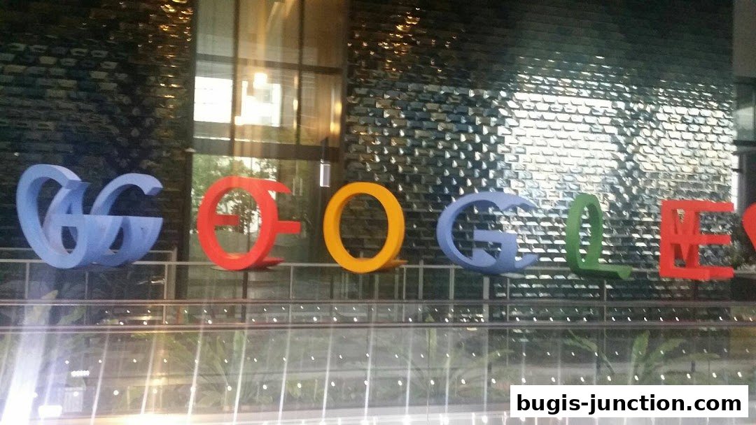The iconic Google logo is displayed in large, colorful letters on a modern building facade.