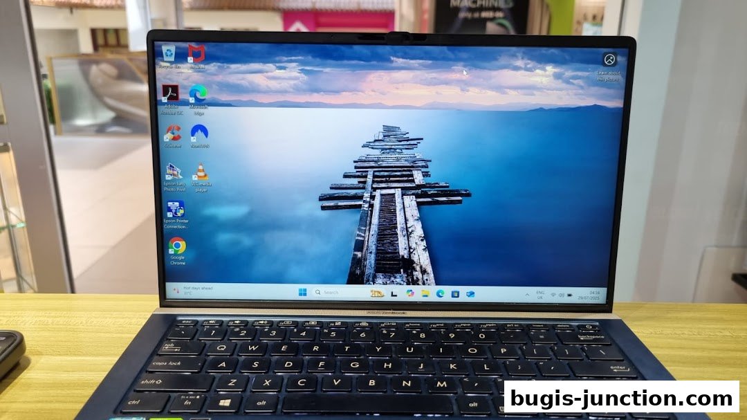 A laptop with a scenic wallpaper is displayed on a wooden surface.