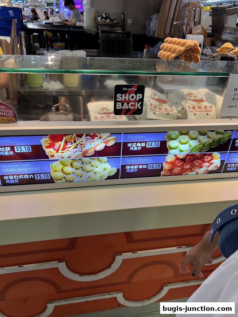 A digital menu board displaying various flavors of Hong Kong Egglets with prices.