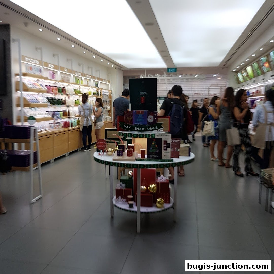 Interior view of a brightly lit Innisfree store with shelves of beauty products and customers browsing.
