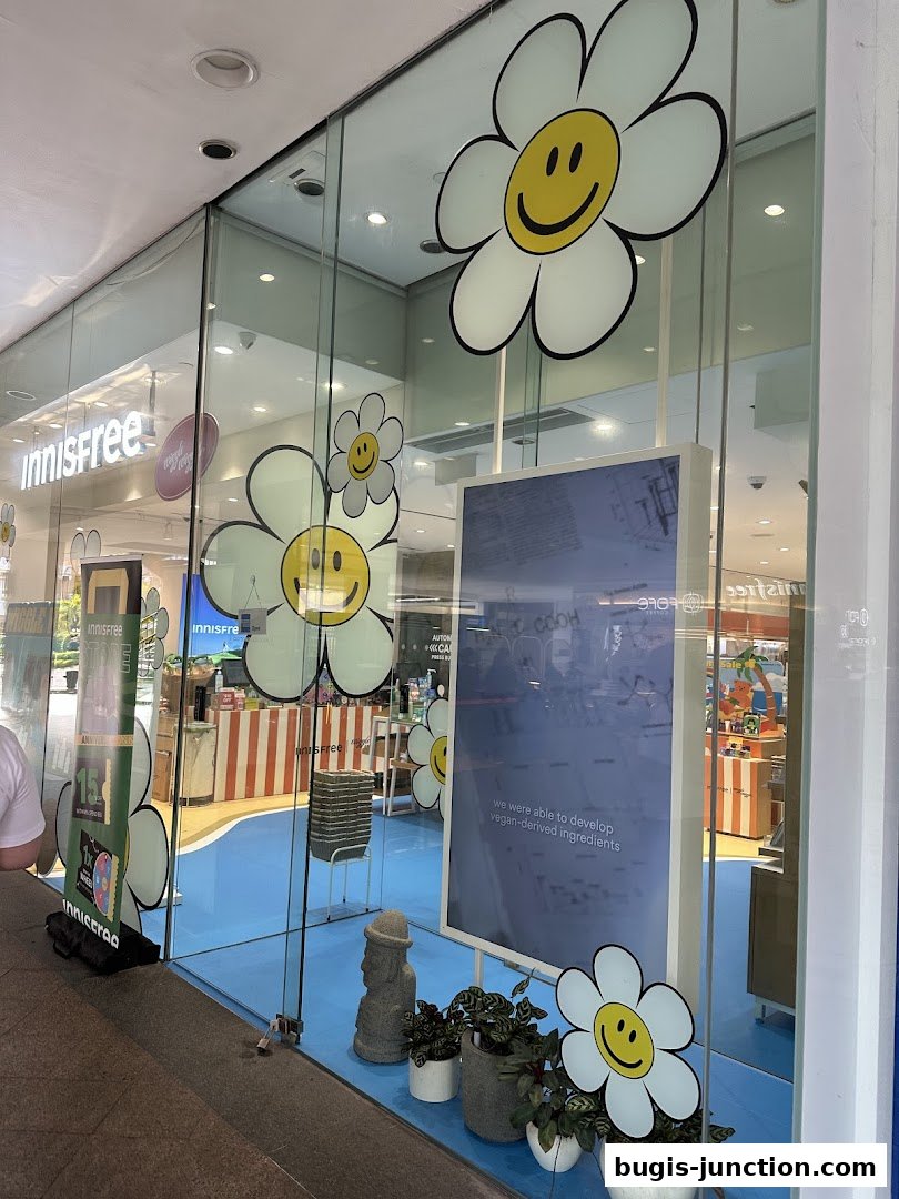 Innisfree Bugis Junction shop front with cheerful flower decorations and product displays visible inside.