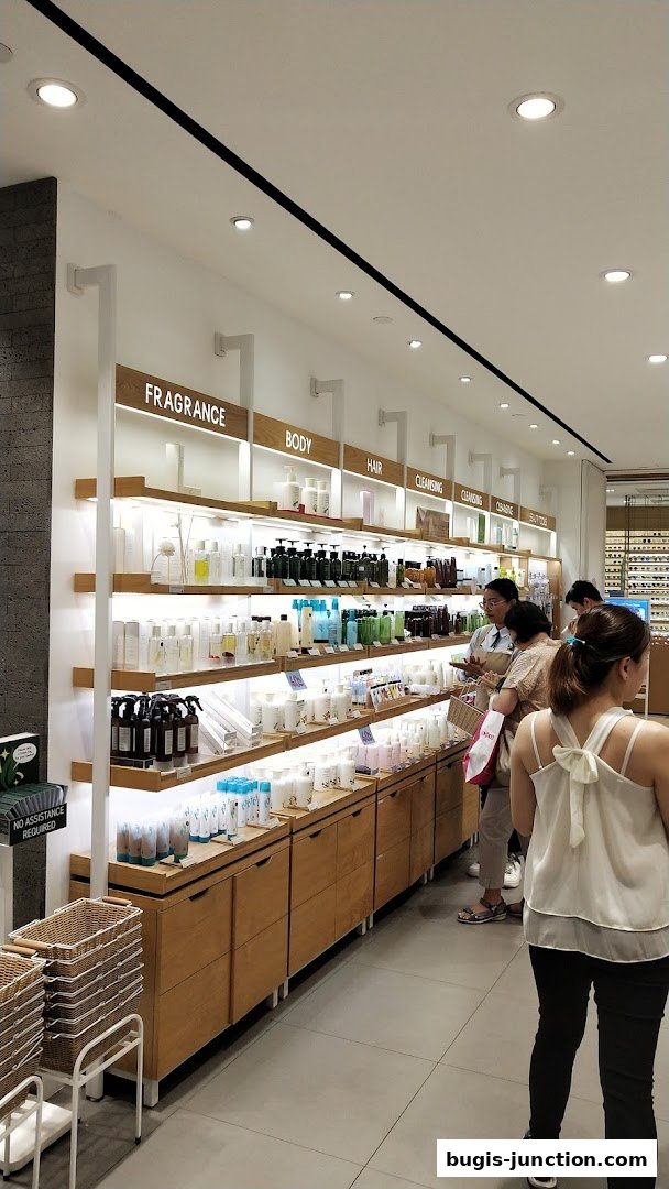 Interior view of a clean, well-lit beauty store with shelves stocked with skincare and body products.