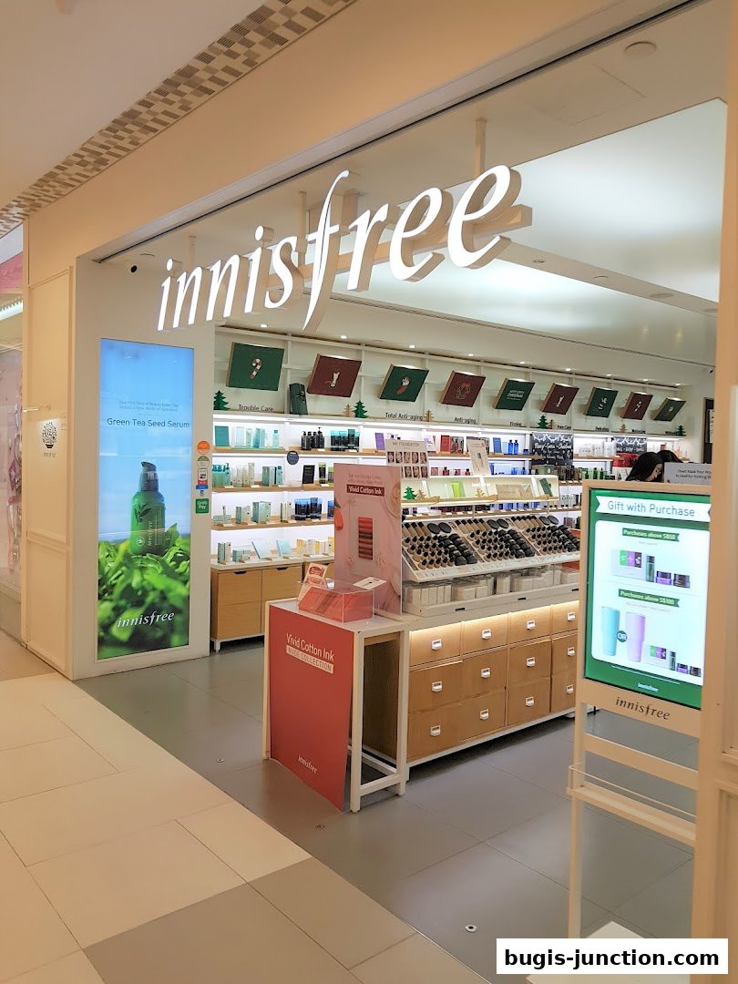 The innisfree shop front displays skincare products and a promotional gift with purchase.