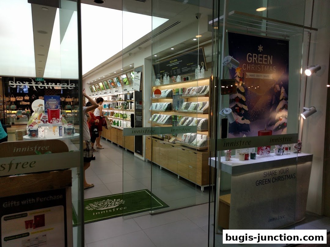Innisfree Bugis Junction shop interior with products on display and a Christmas promotion.