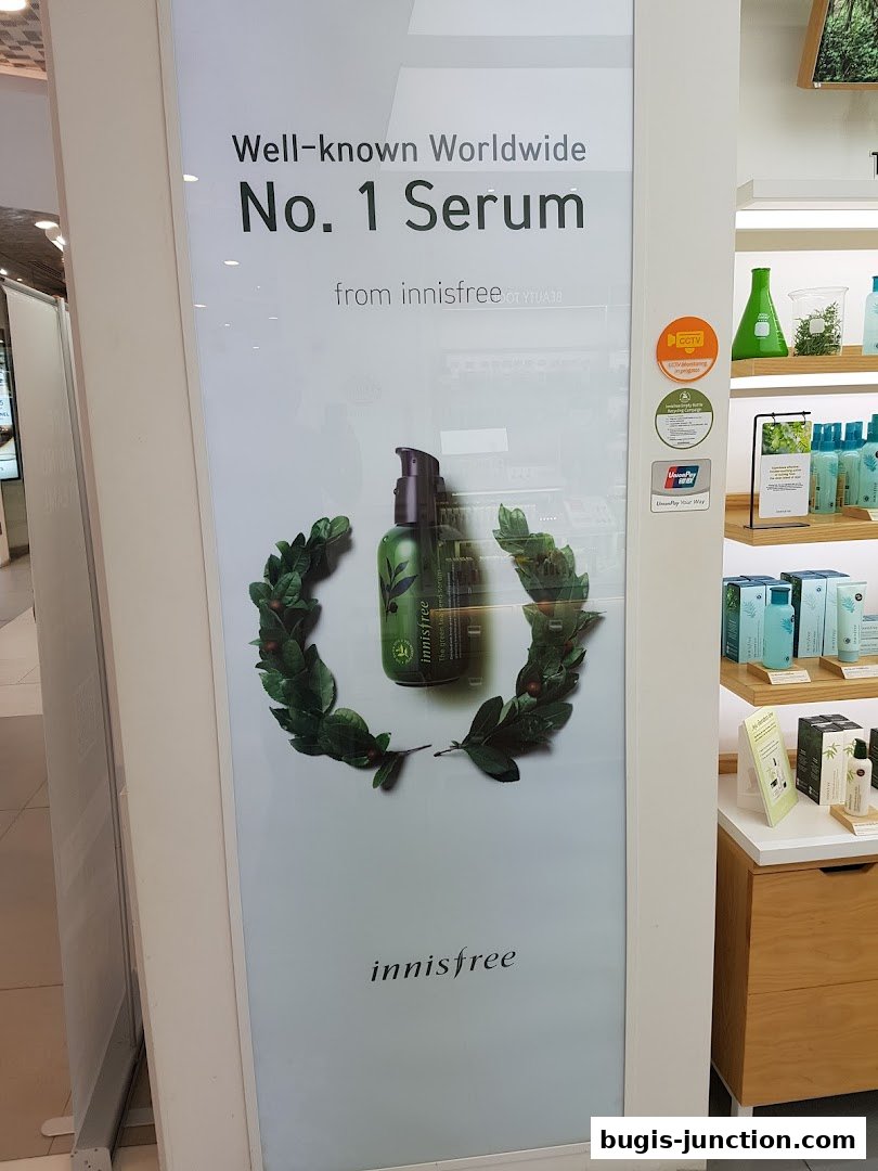 Innisfree shop front display featuring their No. 1 Serum with green leaf accents.