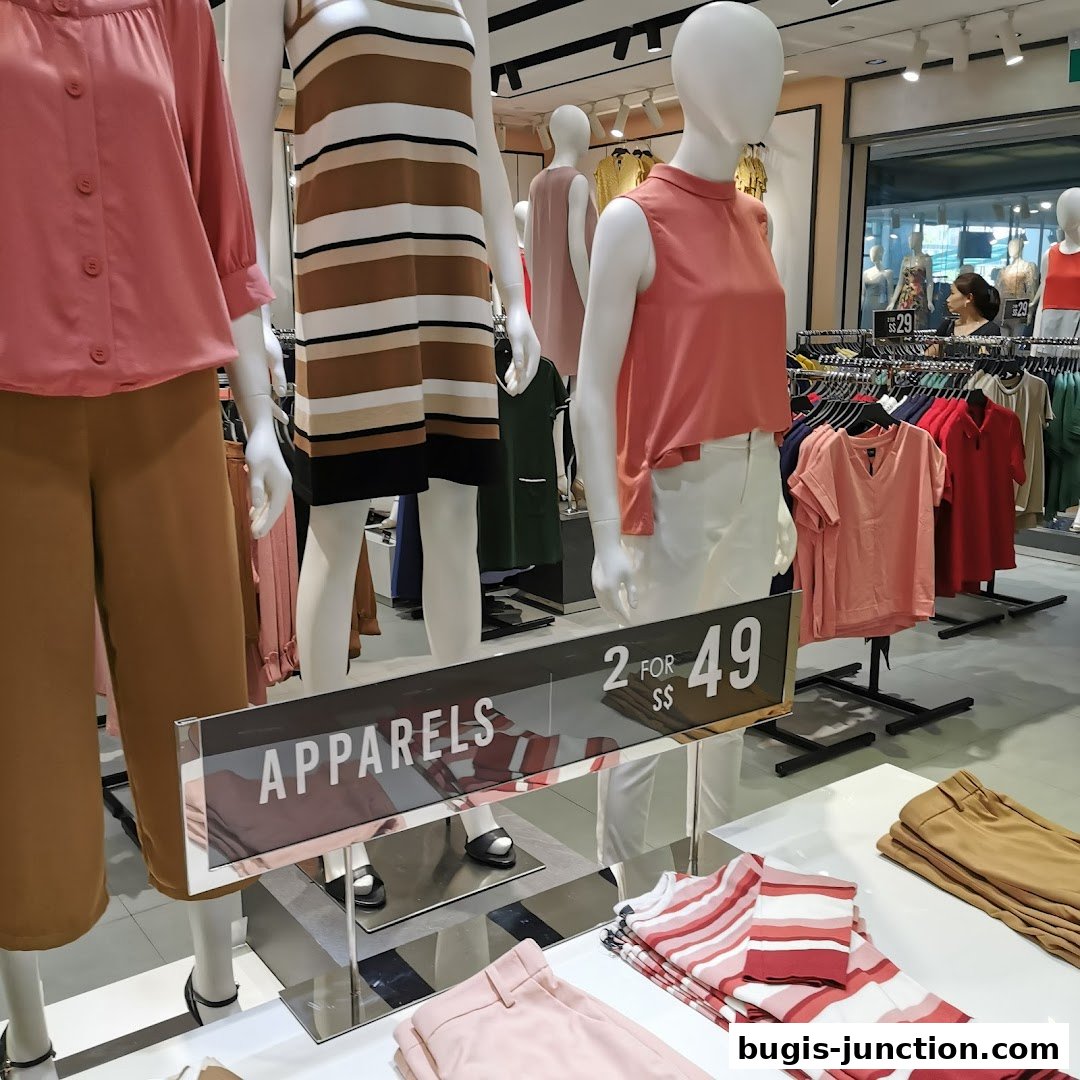Mannequins display fashionable apparel with a promotional sign for 2 for S$49.