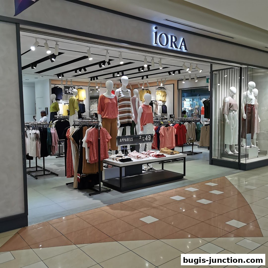 The iORA Bugis Junction shop displays a variety of women's apparel on mannequins and racks.