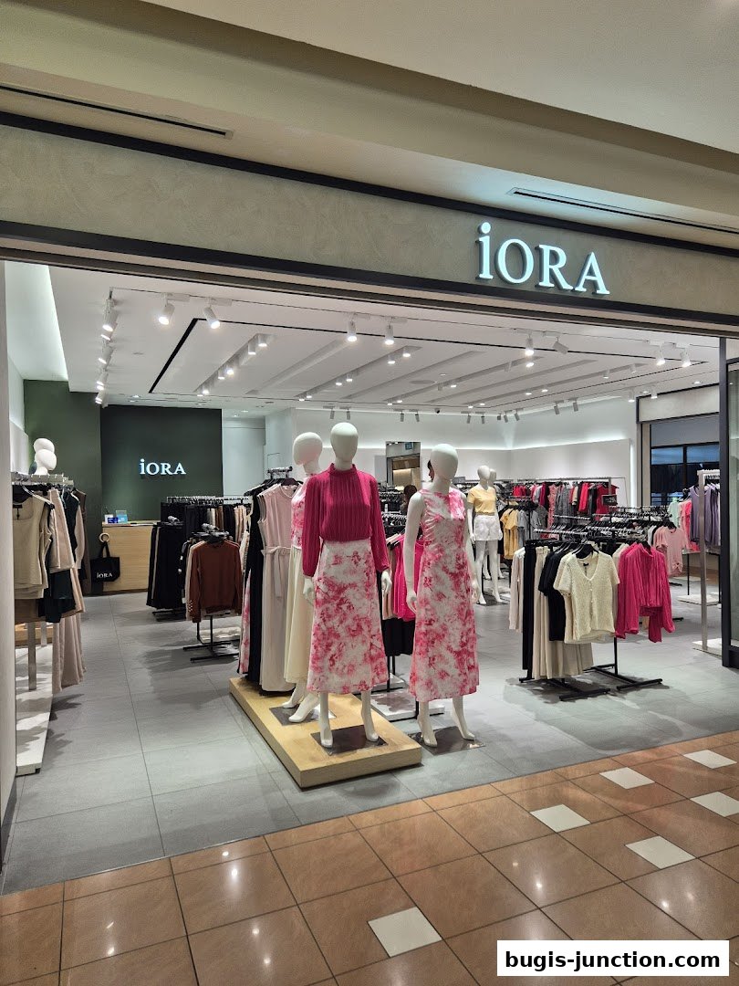 The entrance of the iORA fashion store at Bugis Junction, showcasing mannequins in stylish outfits.