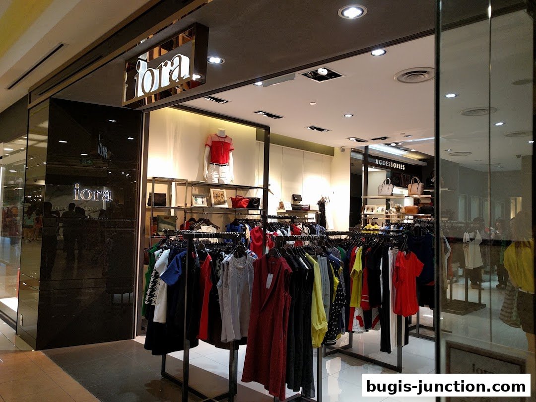 The entrance of the iORA fashion store showcasing racks of colorful clothing and accessories.