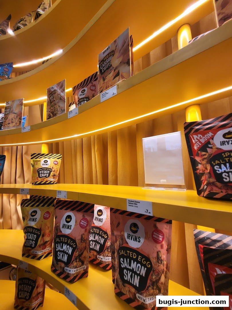 Shelves display various flavors of IRVINS snacks, including salted egg salmon skin and potato chips.
