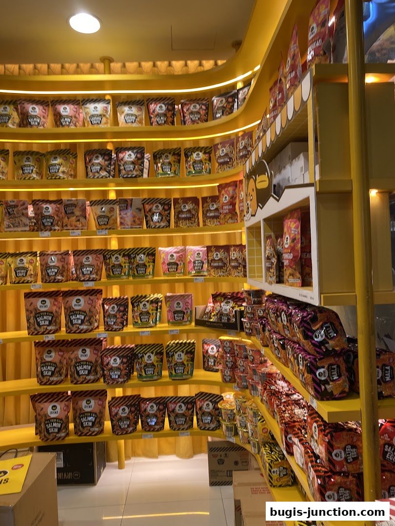 Shelves stocked with various IRVINS snacks, including salted egg salmon skin and mala chips.
