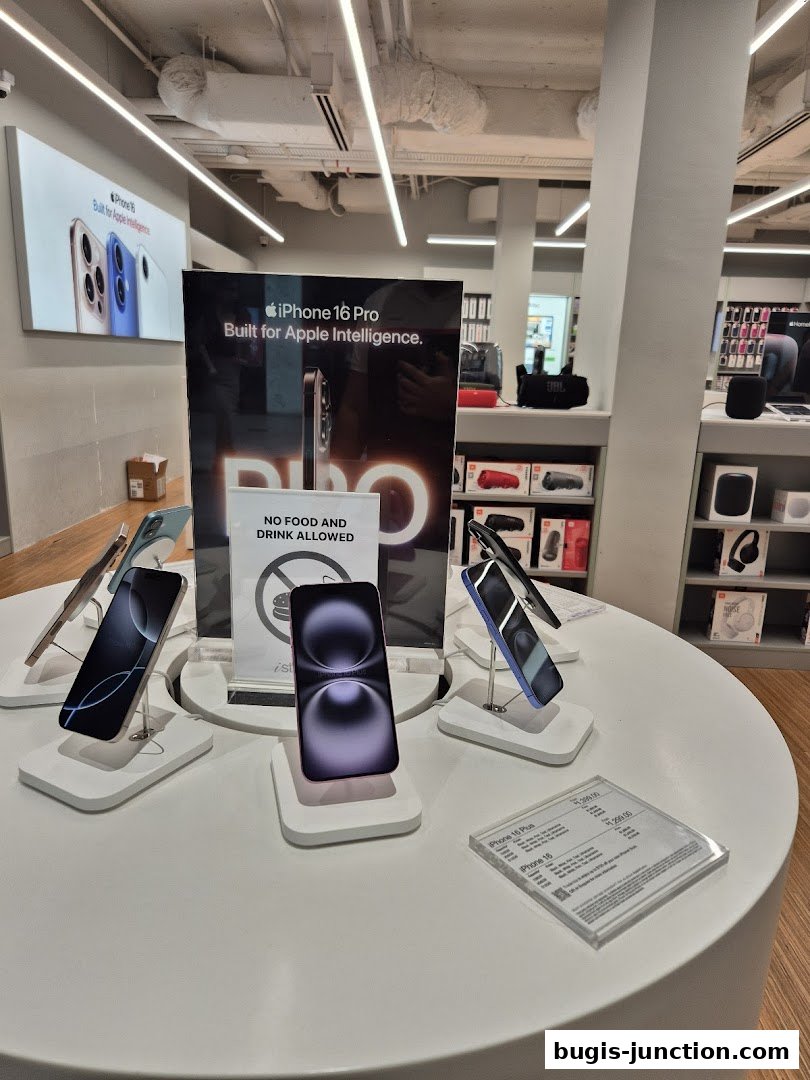 Display of new iPhones on a white circular table inside a modern electronics store.