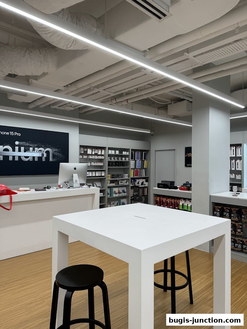 Interior of an iStudio store showcasing Apple products and accessories with a display table.