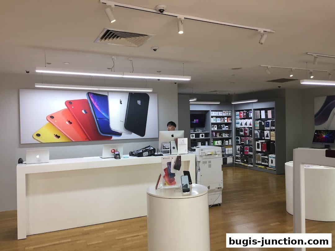 Interior of an Apple store showcasing iPhones, MacBooks, and accessories on display.