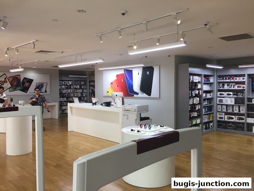 Interior of an iStudio store showcasing Apple products and accessories on display.