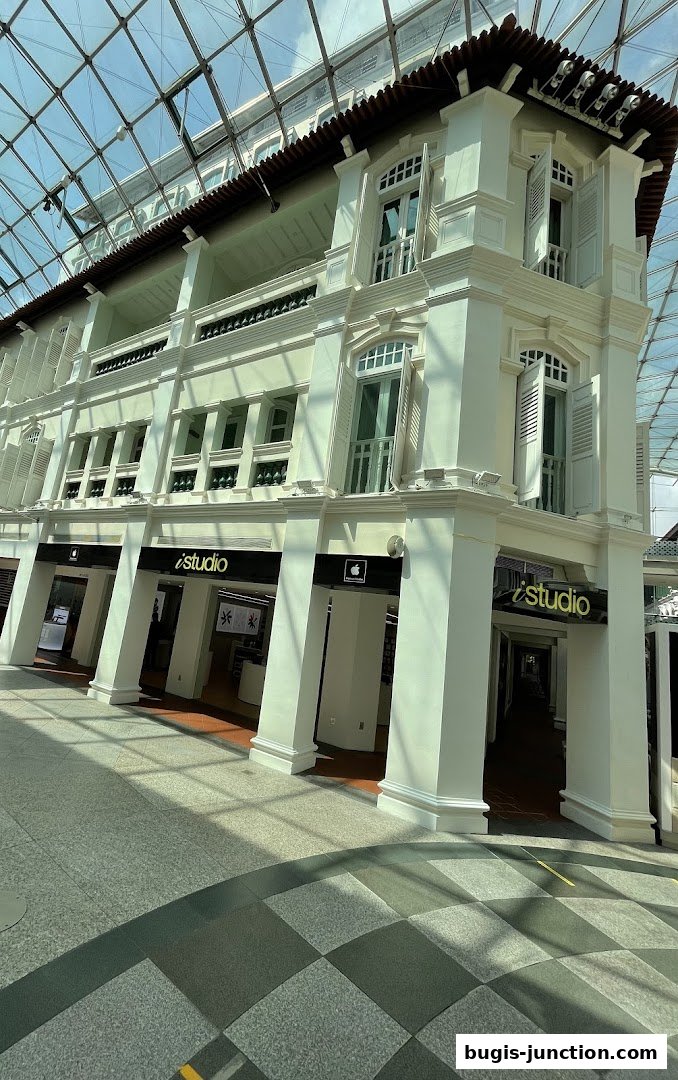 The iStudio Bugis Junction store with its distinctive Apple branding and modern facade.