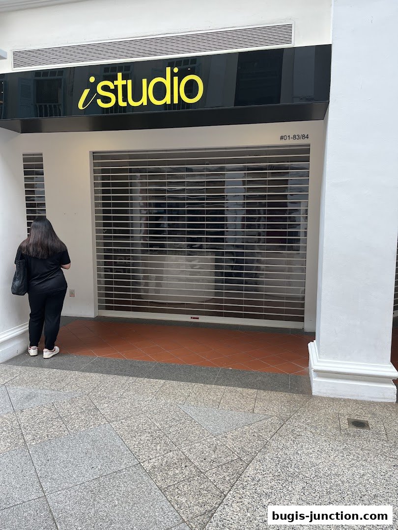 The iStudio Bugis Junction shop front with its roller shutter down.
