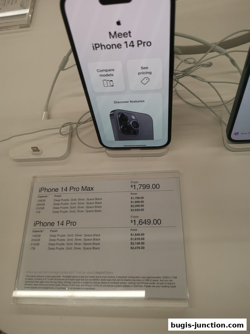 Display of iPhone 14 Pro and iPhone 14 Pro Max with pricing and features.