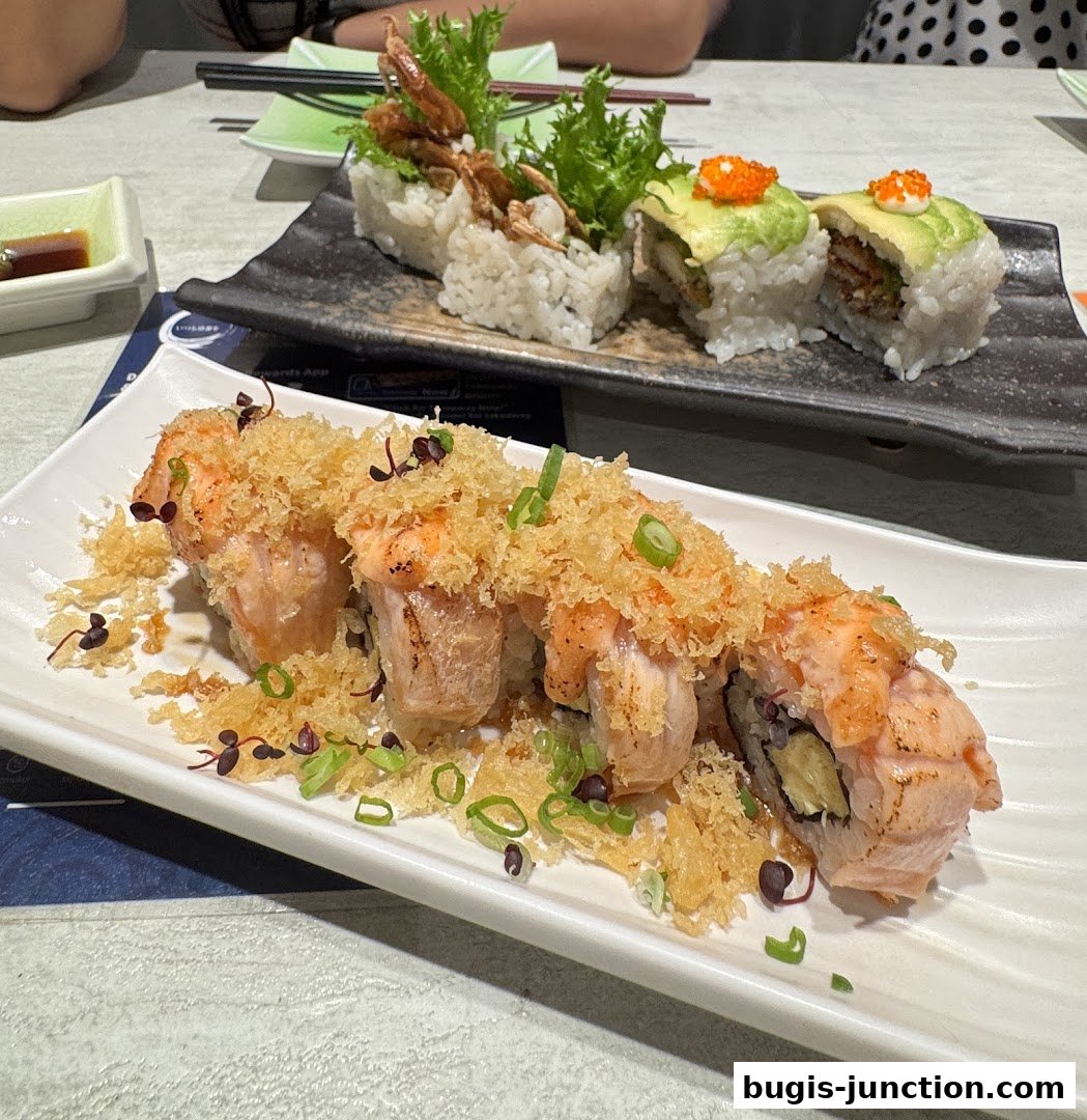 A close-up of delicious sushi rolls, featuring salmon and avocado, presented on white plates.