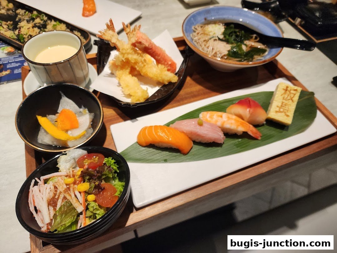 A variety of Japanese dishes including sushi, tempura, soba noodles, and salad.