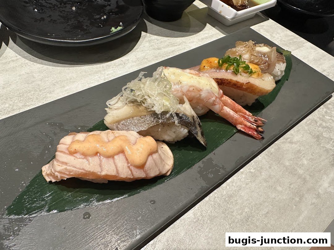A close-up of a platter of assorted sushi, featuring salmon, shrimp, and other seafood.