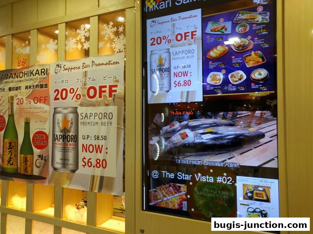 Promotional displays for sake and Sapporo beer with food images at Itacho Sushi.