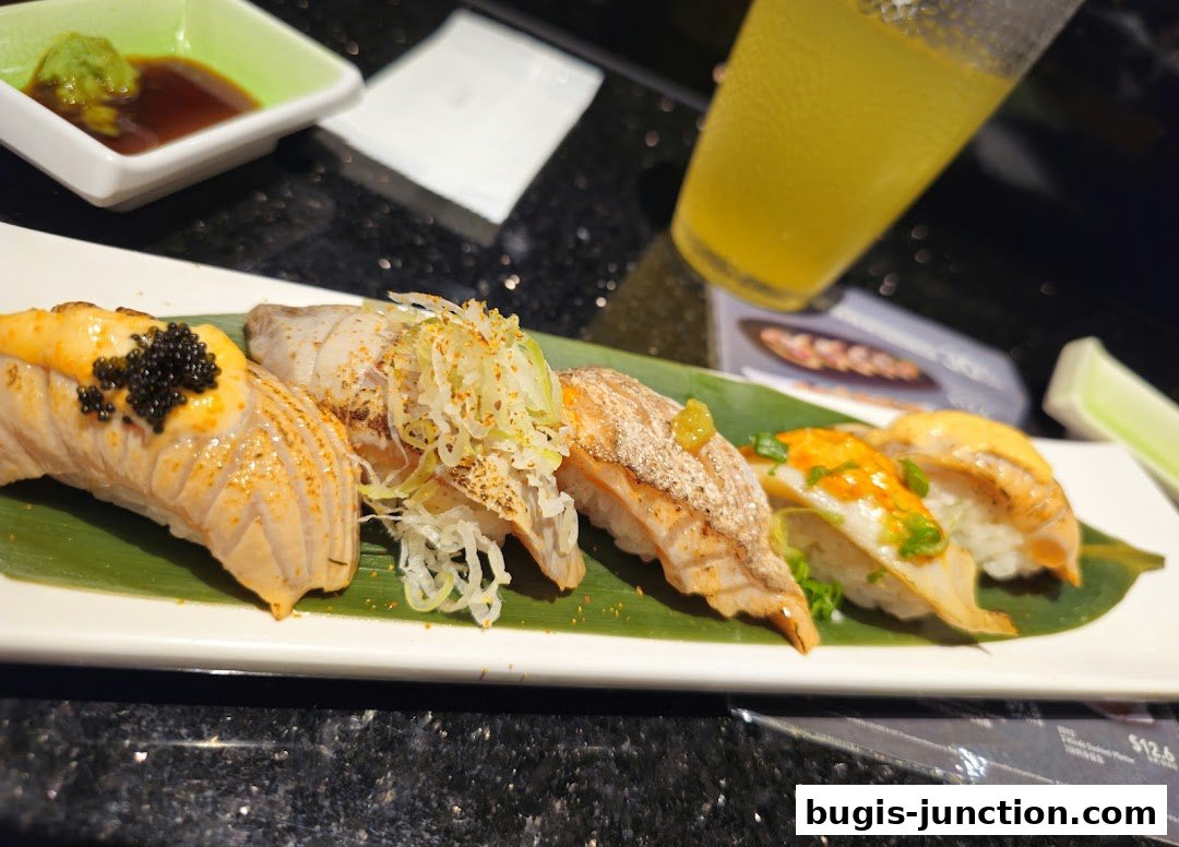 A plate of assorted sushi with salmon and other toppings, served with wasabi and soy sauce.