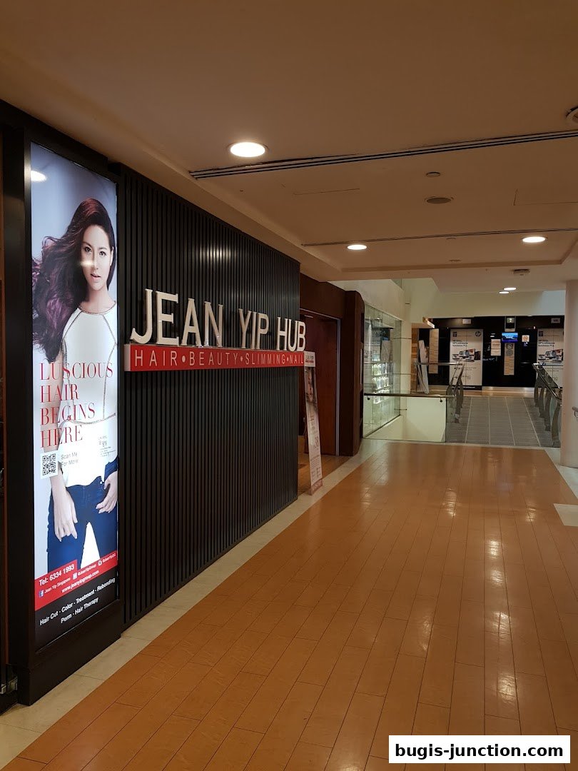 The exterior of Jean Yip Hub, a hair, beauty, and slimming salon, with a large advertisement.
