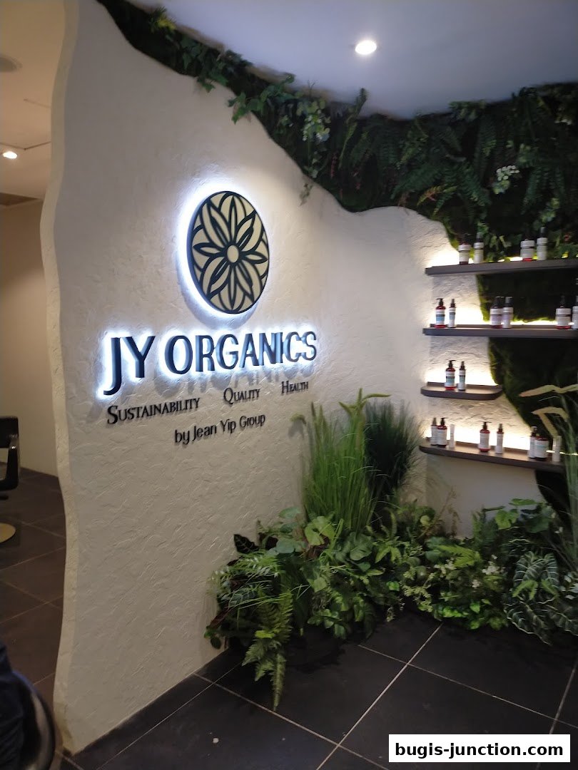 Interior shot of Jean Yip Organics with illuminated signage and shelves of products.