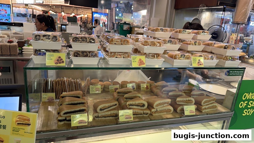 A display case filled with various sweet pastries and snacks, including rolls and pancakes.