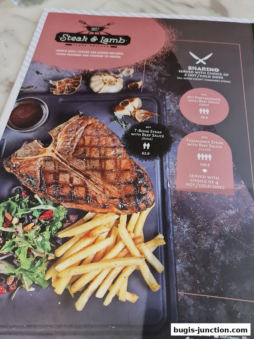 A menu page from Josh's Grill featuring flame-grilled steaks and lamb dishes.