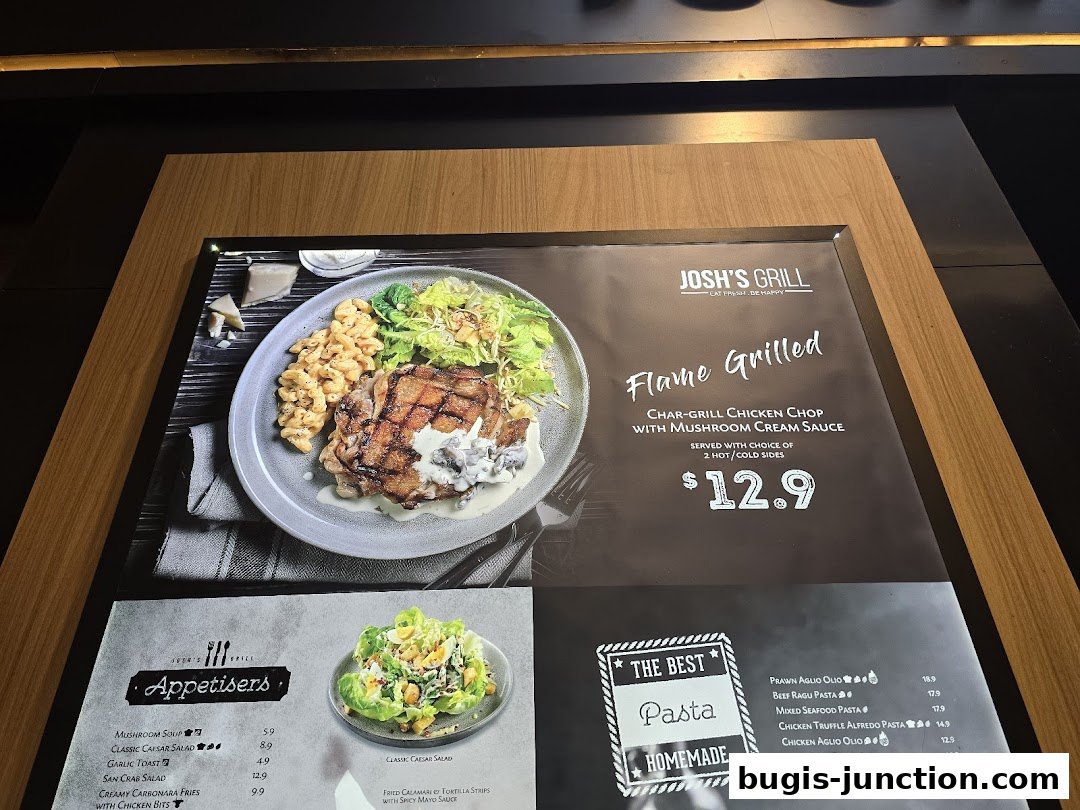 A menu display for Josh's Grill featuring a flame-grilled chicken chop and various appetizers and pasta dishes.
