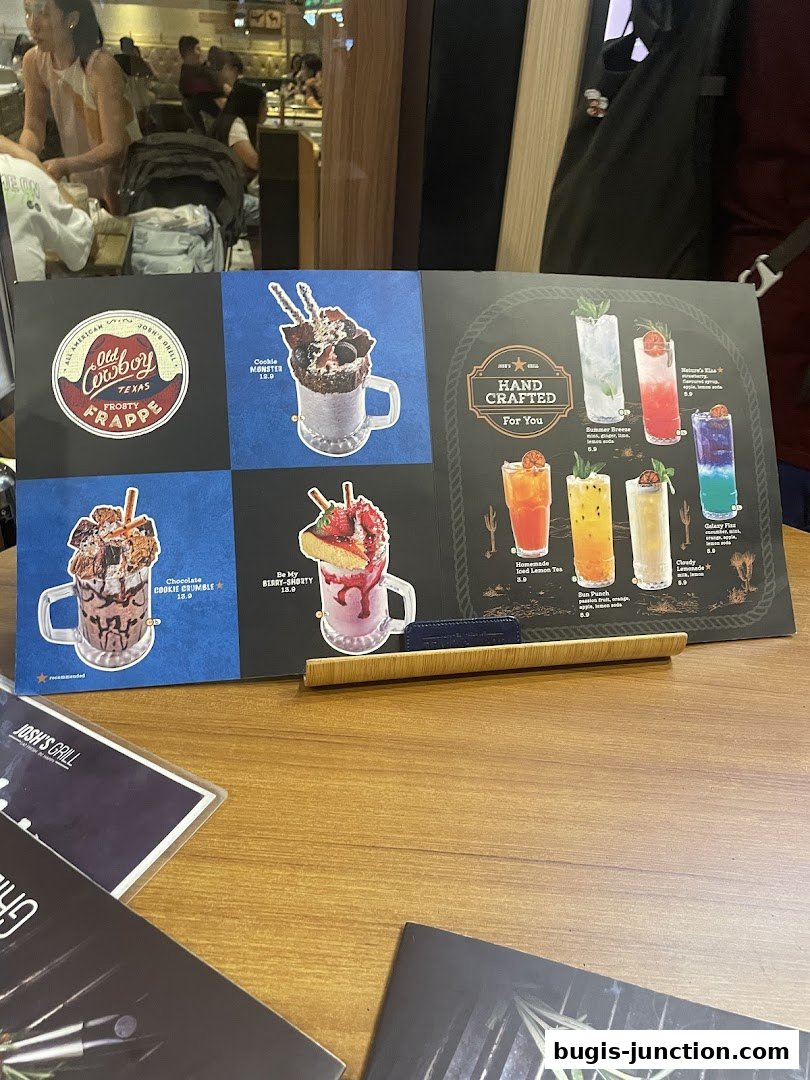 A menu board from Josh's Grill showcasing desserts and handcrafted drinks.