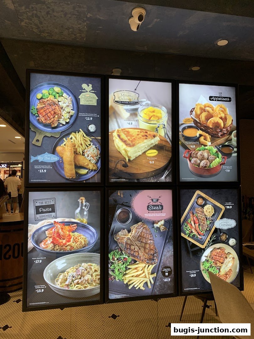 A display of illuminated menu boards showcasing various dishes from Joshs Grill.