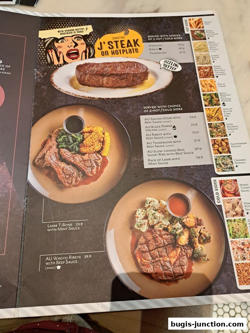 A menu featuring various steak dishes, including J's Steak on Hotplate, Lamb T-Bone, and Wagyu Ribeye.