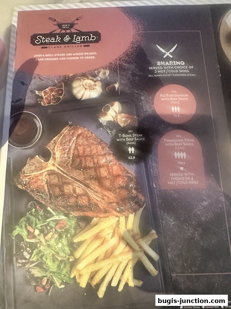 A menu page from Josh's Grill featuring steak and lamb dishes, with a large T-bone steak pictured.