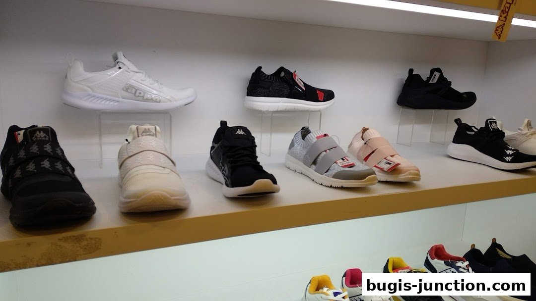A display of various Kappa brand athletic shoes on shelves in a retail store.