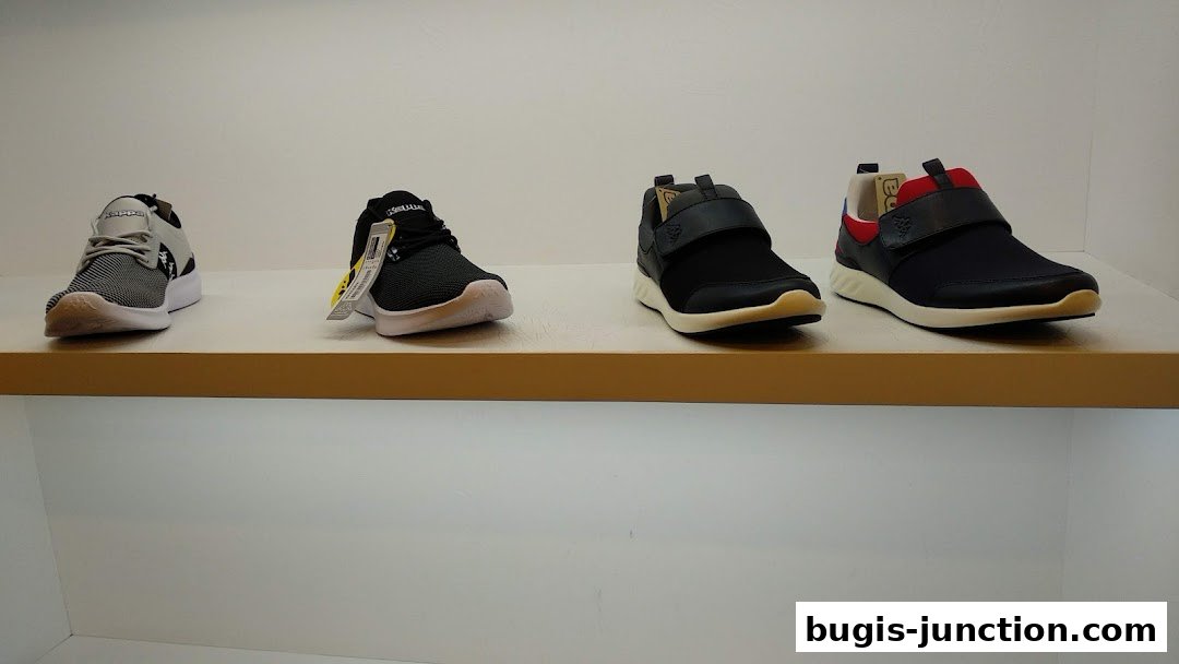 Four pairs of Kappa brand athletic shoes displayed on a shelf.