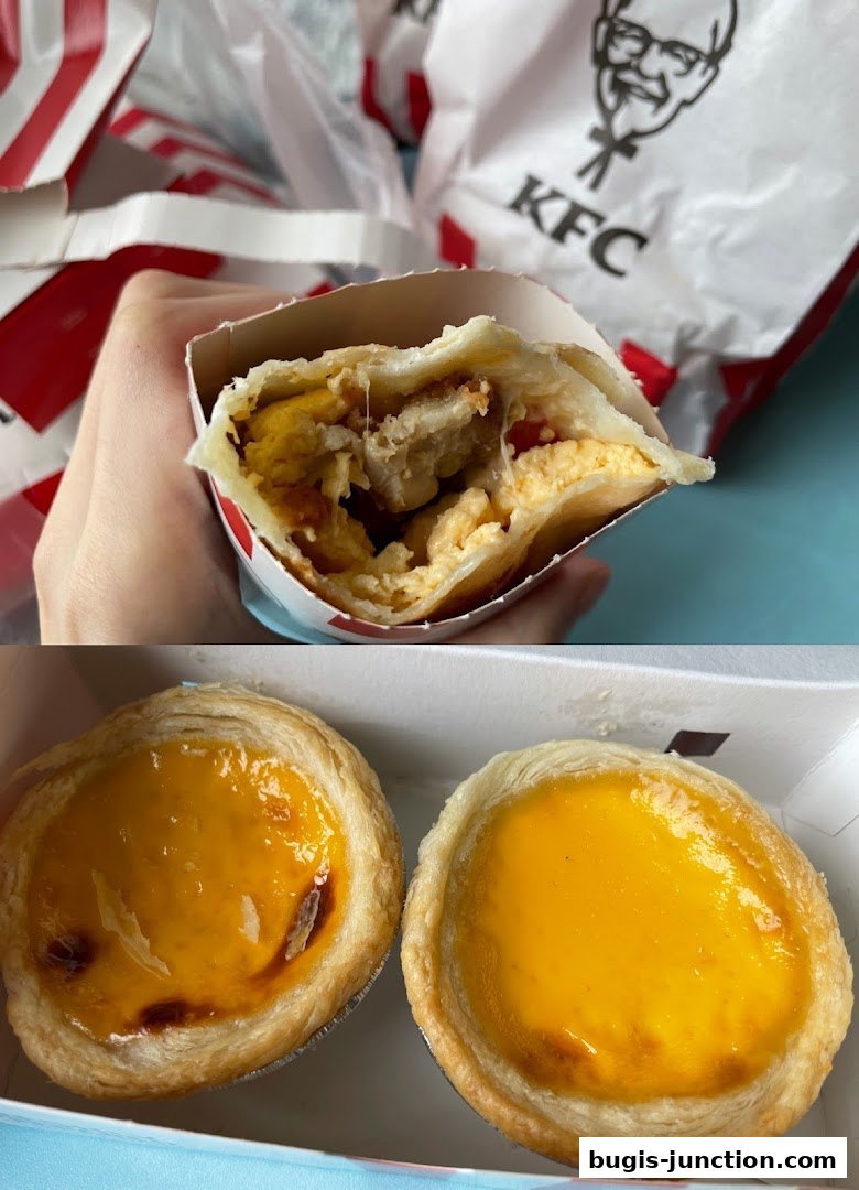 A hand holds a KFC wrap with chicken and eggs, next to two egg tarts.